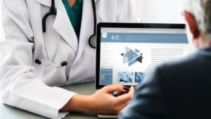 Doctor showing person information on laptop