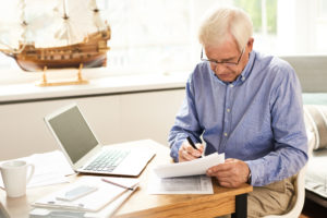 senior-man-filing-tax-report